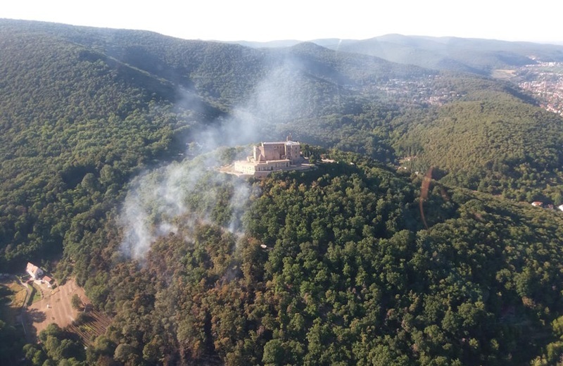 Rauchsäule über Hambacher Schloss während des Waldbrandes am Hambacher Schloss im Jahr 2022. Das Bild verlinkt zu weiteren Informationen über das Thema Waldbrandprävention in Neustadt an der Weinstraße.