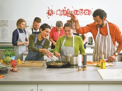 Bild vergr&ouml;&szlig;ern: Menschen kochen gemeinsam in einer Küche
